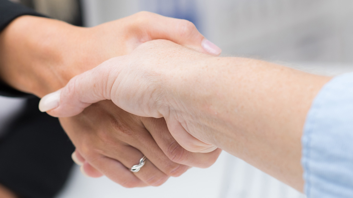 A handshake between two people.